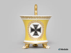 Germany, Imperial. A Yellow Glazed Kpm Clawfoot Cup With Iron Cross Motif