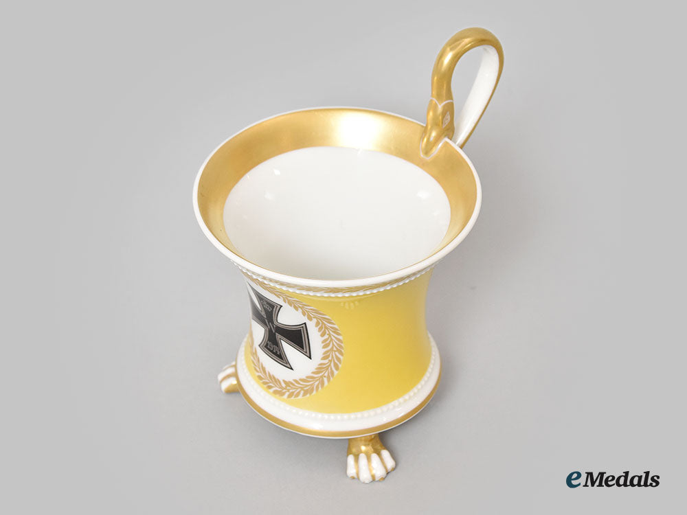 germany,_imperial._a_yellow_glazed_kpm_clawfoot_cup_with_iron_cross_motif_l22_mnc9390_609