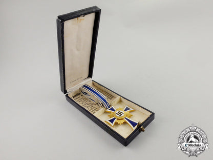a_cased_gold_grade_mother’s_cross_with_instructions_for_wear_m17-000078