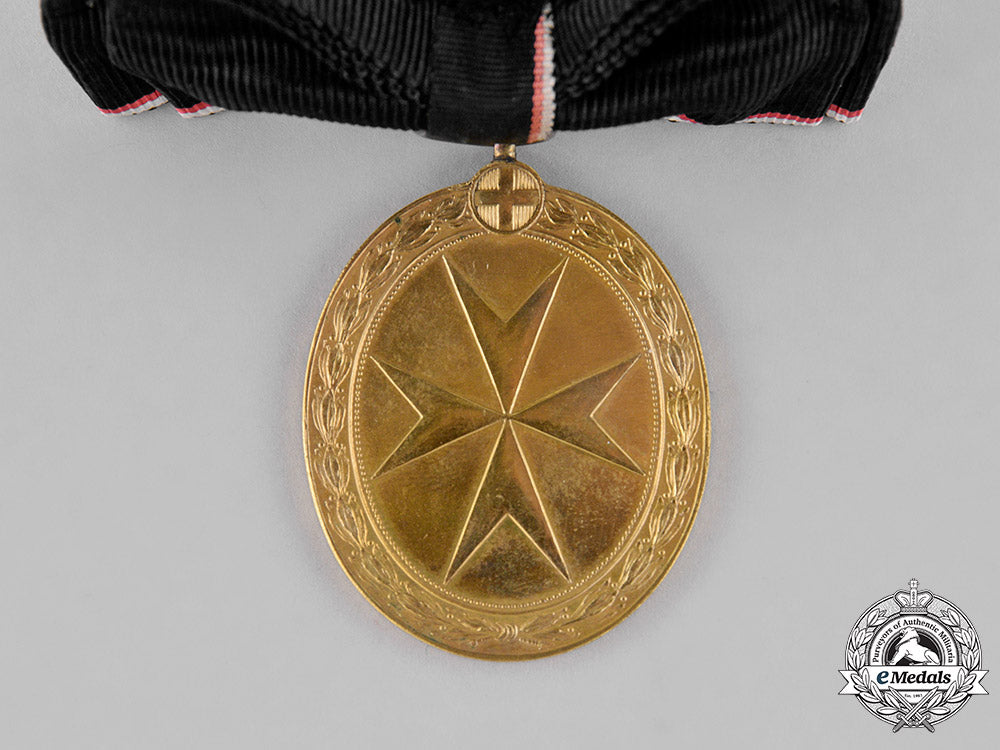austria,_empire._an_order_of_the_knights_of_malta_gold_merit_medal,_c.1918,_with_wd_ribbon_m18_9889