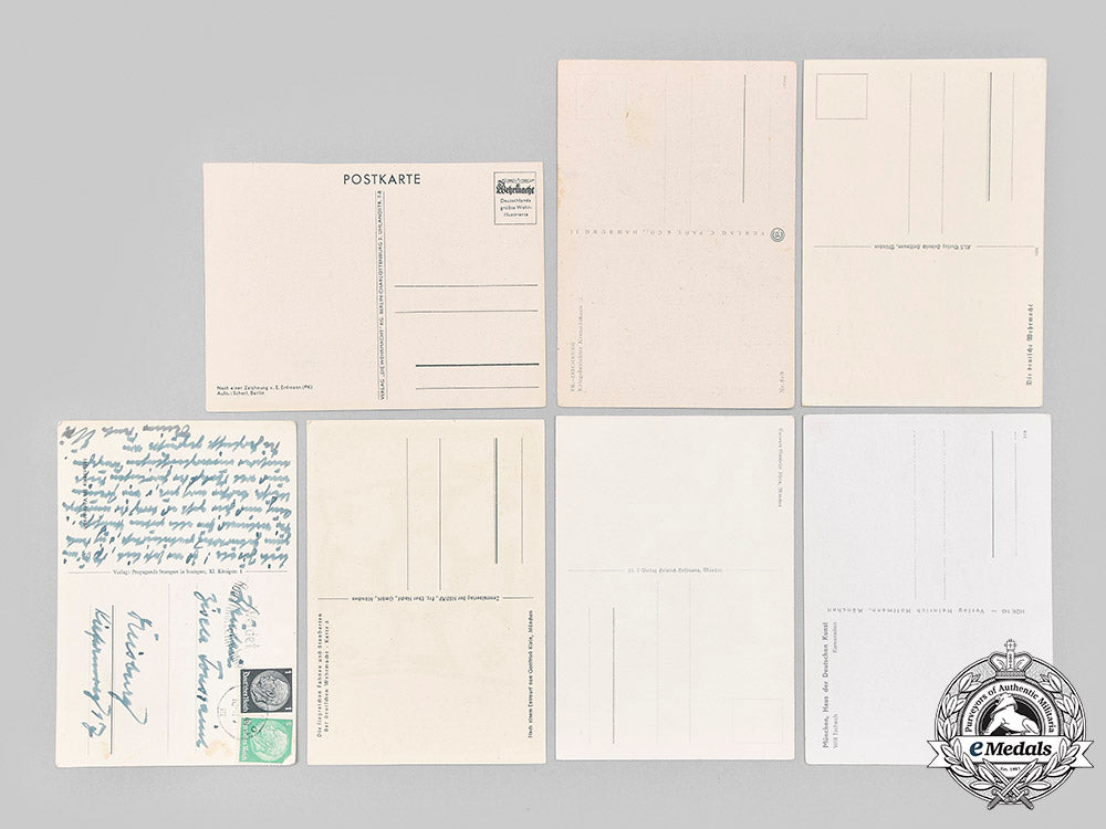 germany,_wehrmacht._an_eastern_front_medal_and_award_document,_with_commemorative_postcards_m20_1307