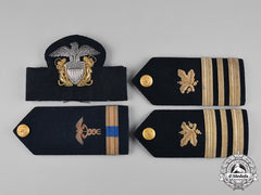 United States. A Navy Cap Badge And Three Shoulder Boards